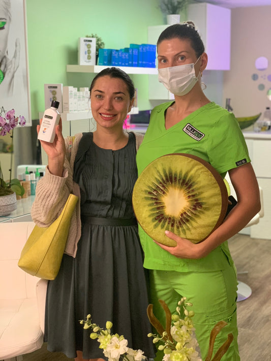 A client with bright, glowing skin after receiving a detoxifying facial treatment at Kiwi Spa.